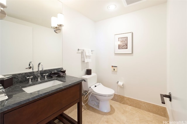 bathroom with vanity, toilet, and tile patterned flooring