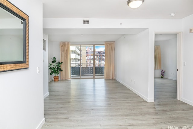 spare room featuring light wood-type flooring