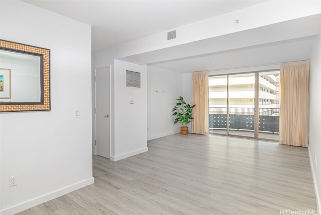 spare room featuring light hardwood / wood-style flooring