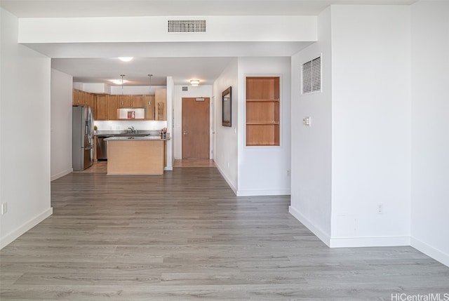 kitchen with a center island, stainless steel appliances, hanging light fixtures, and dark hardwood / wood-style flooring