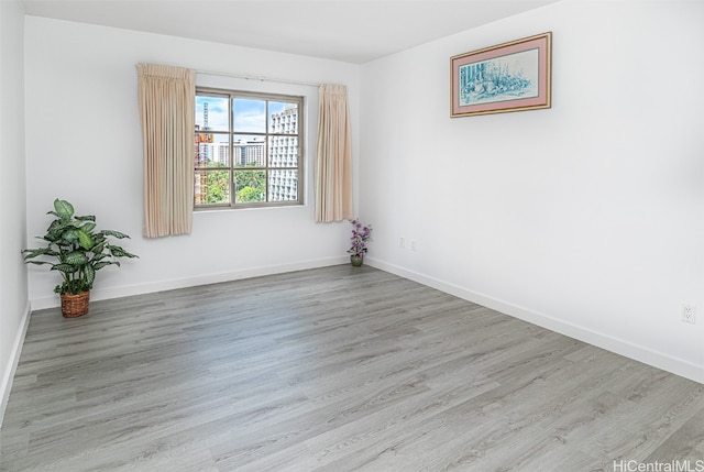 unfurnished room with light wood-type flooring