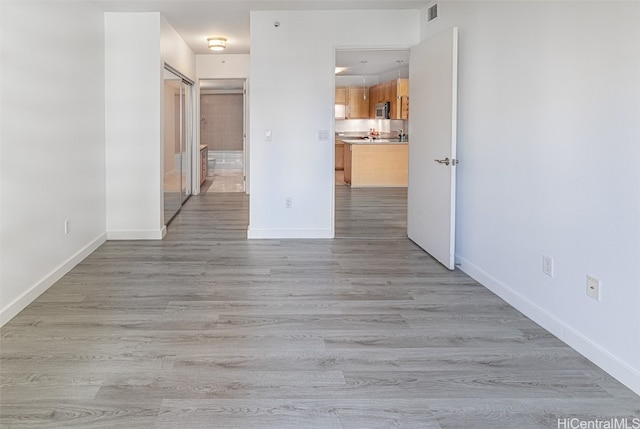 empty room with light hardwood / wood-style floors