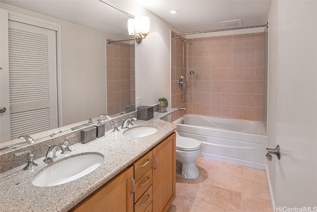 full bathroom with vanity, toilet, and tiled shower / bath combo