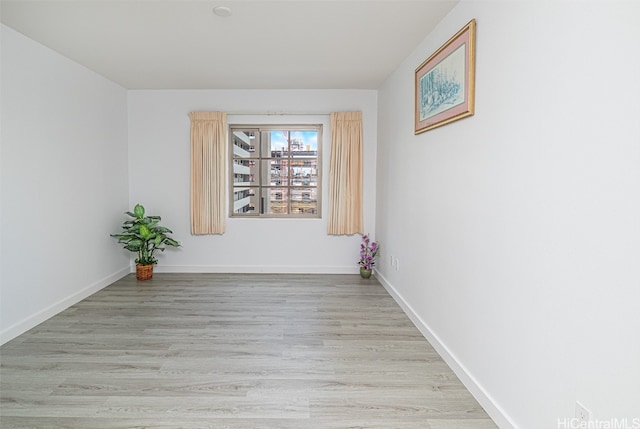 unfurnished room with light wood-type flooring