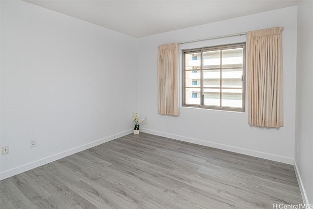 unfurnished room with hardwood / wood-style flooring