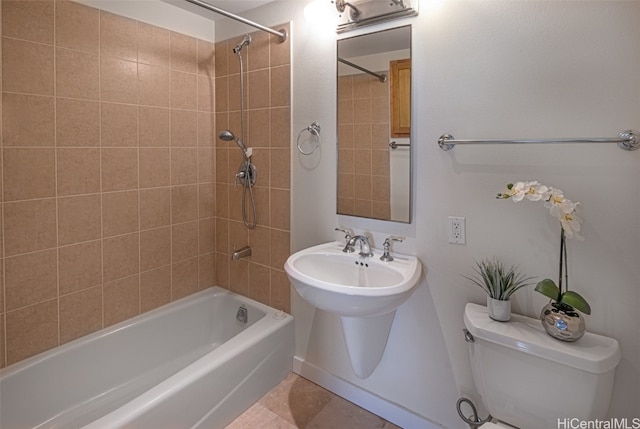 bathroom with tiled shower / bath combo and toilet