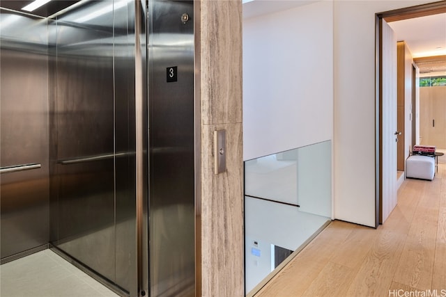 bathroom with wood-type flooring and elevator