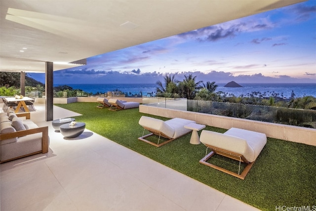 exterior space with a patio, outdoor lounge area, a water view, and a lawn