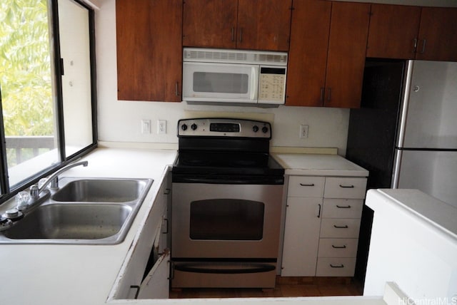 kitchen featuring stainless steel range with electric stovetop and sink