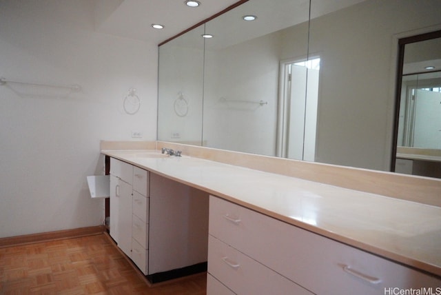 bathroom with vanity and parquet flooring