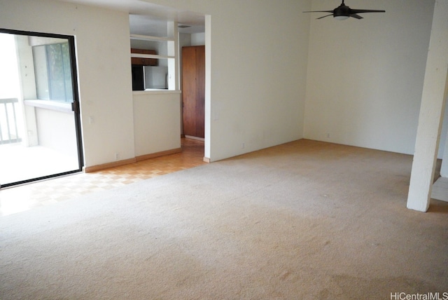 unfurnished room with ceiling fan and light colored carpet