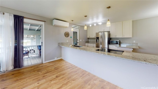 kitchen featuring sink, white cabinetry, stainless steel fridge with ice dispenser, hanging light fixtures, and kitchen peninsula