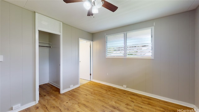 unfurnished bedroom with light hardwood / wood-style flooring, a closet, and ceiling fan