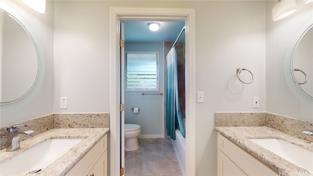 full bathroom featuring vanity, shower / bath combination with curtain, and toilet