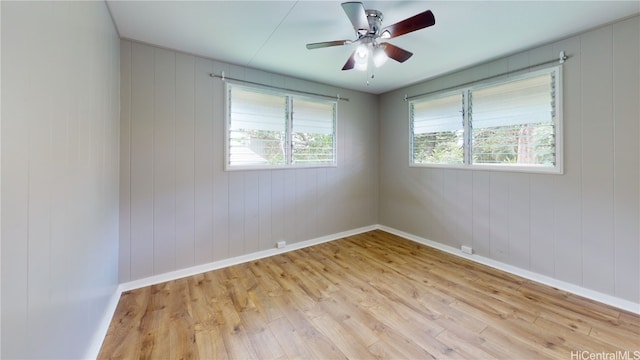 empty room with ceiling fan and light hardwood / wood-style floors