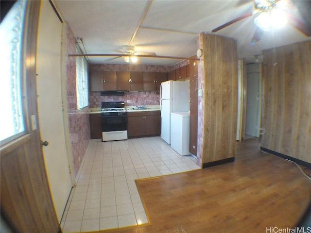 kitchen with white appliances, ceiling fan, decorative backsplash, and sink