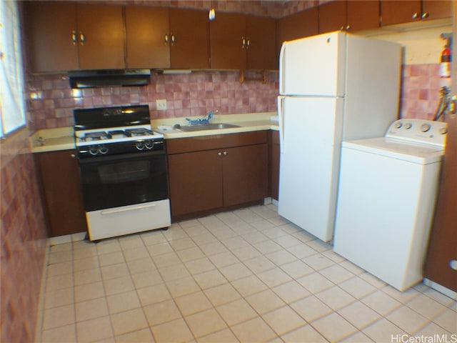 kitchen featuring white appliances, tasteful backsplash, washer / clothes dryer, sink, and range hood