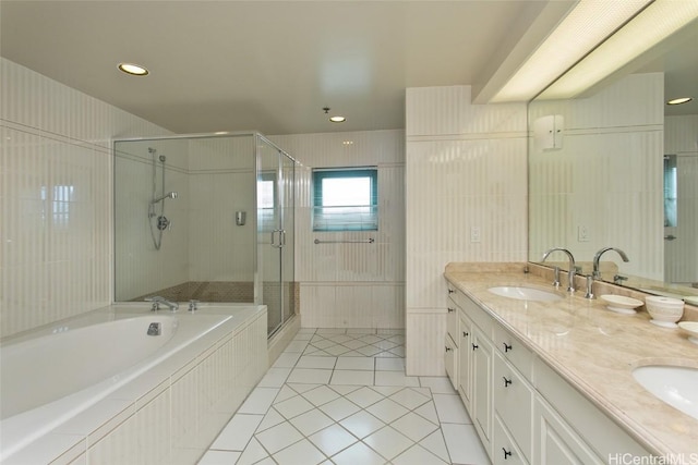 full bathroom with a garden tub, double vanity, a stall shower, a sink, and tile patterned floors