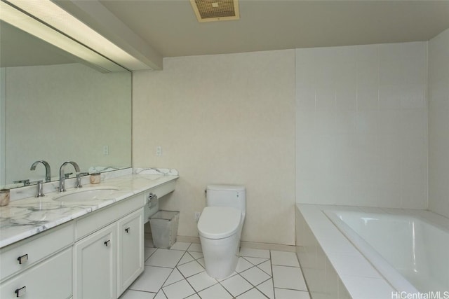 full bathroom with tiled bath, toilet, vanity, visible vents, and tile patterned floors