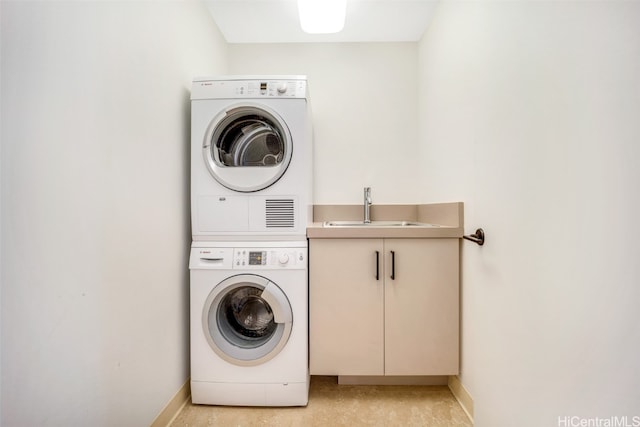 clothes washing area with sink and stacked washer / drying machine