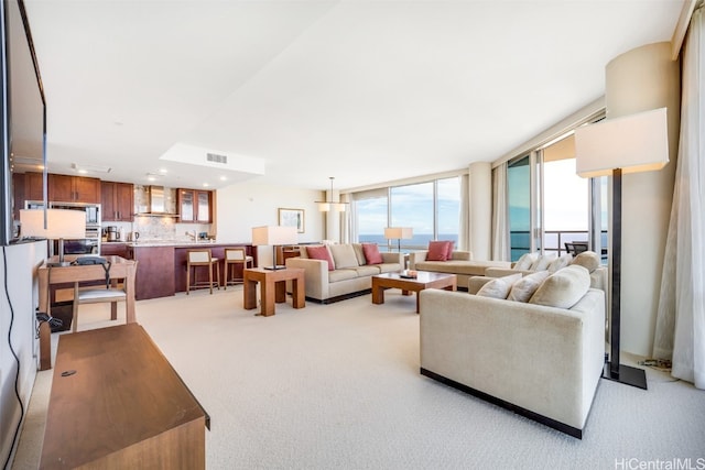 living room featuring light carpet and floor to ceiling windows