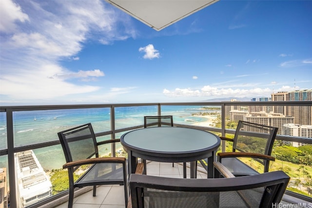 balcony featuring a water view and a view of the beach