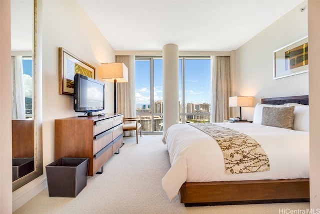 bedroom with expansive windows and light colored carpet