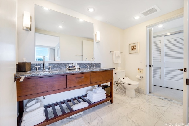 bathroom with vanity and toilet