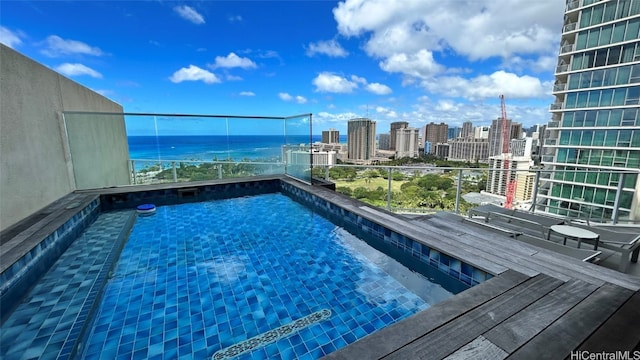 view of pool with a water view