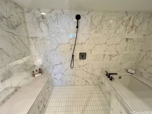 bathroom featuring shower with separate bathtub and tile walls