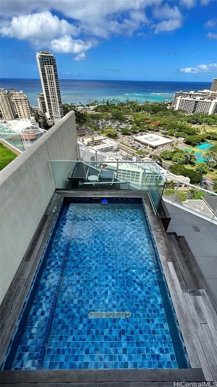 view of swimming pool featuring a water view