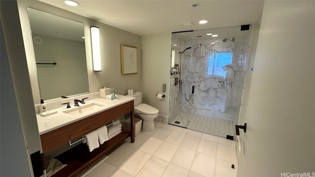 bathroom featuring a shower with door, toilet, tile patterned floors, and vanity