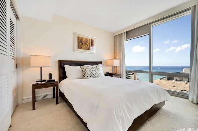 carpeted bedroom with a water view