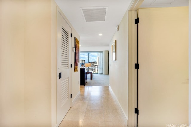 hall featuring light tile patterned floors