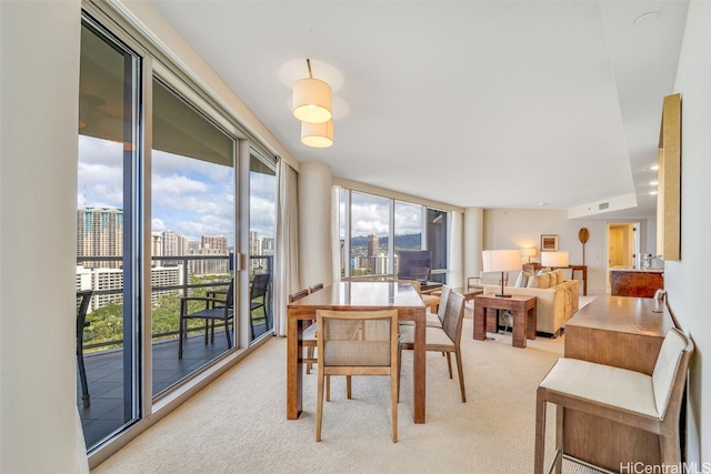 carpeted dining room with expansive windows and a wealth of natural light