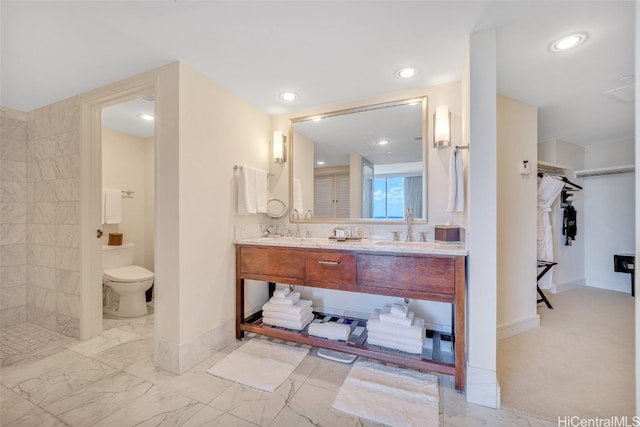 bathroom featuring vanity, toilet, and walk in shower