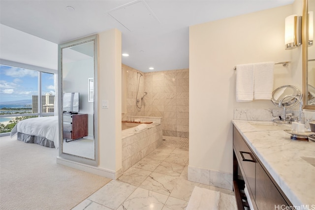 bathroom with a tile shower and vanity