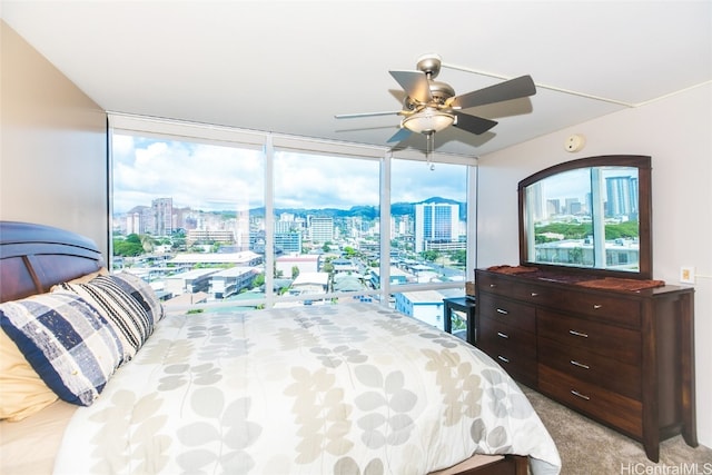 carpeted bedroom with ceiling fan and access to exterior