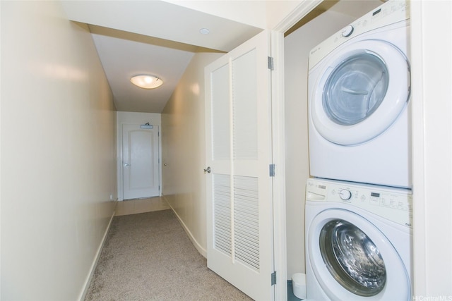 laundry area featuring estacked washer and dryer and light colored carpet