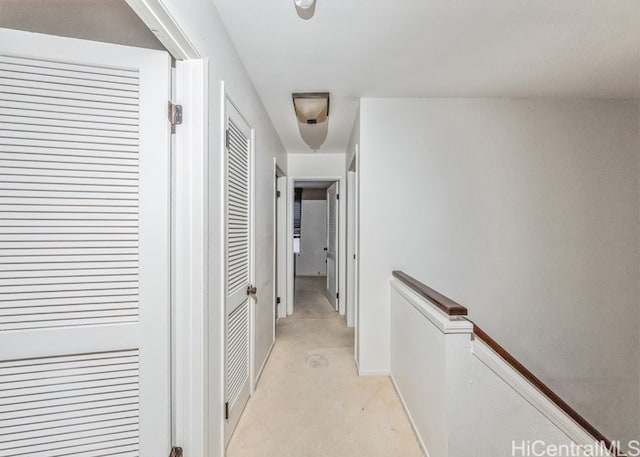 hallway featuring light colored carpet