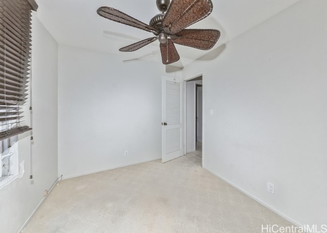 spare room with light carpet and ceiling fan