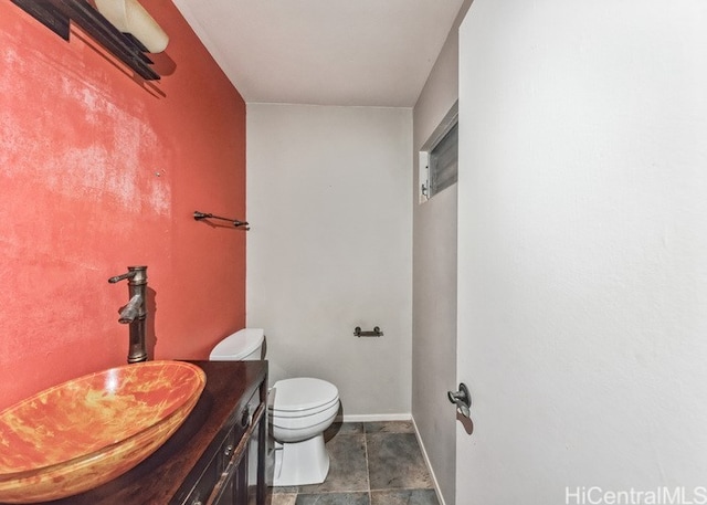 bathroom featuring toilet and vanity