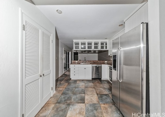 kitchen featuring white cabinetry, stainless steel appliances, and sink