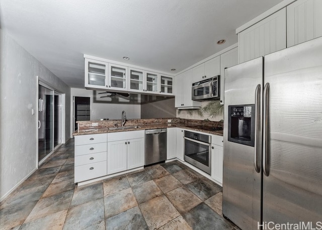 kitchen featuring stainless steel appliances, sink, and white cabinets