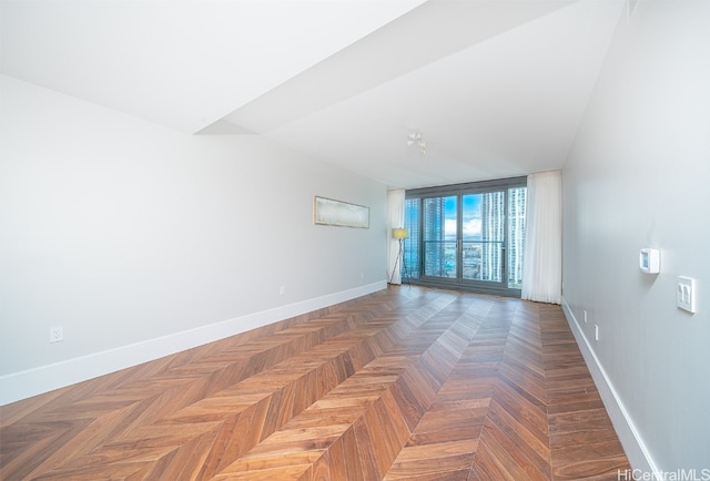 unfurnished room with dark parquet floors