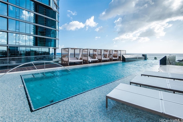 view of swimming pool featuring a water view