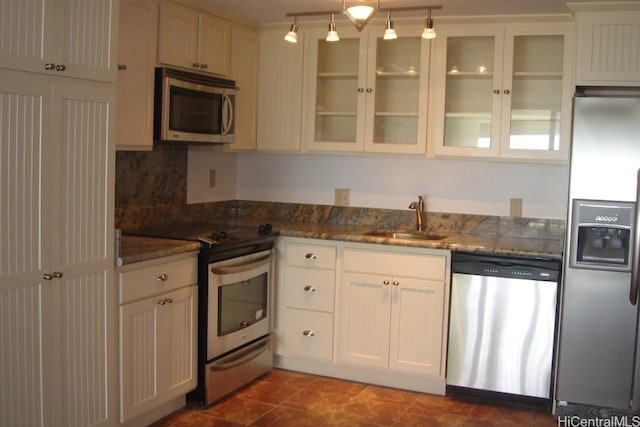 kitchen featuring sink, appliances with stainless steel finishes, decorative light fixtures, and white cabinetry