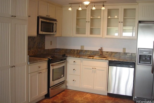 53-567 Kamehameha Hwy Unit Bh-215, Hauula, HI 96717 - kitchen featuring appliances with stainless steel finishes, a sink, dark stone counters, and glass insert cabinets