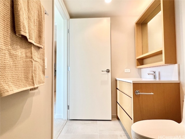 bathroom featuring vanity, toilet, and tile patterned flooring