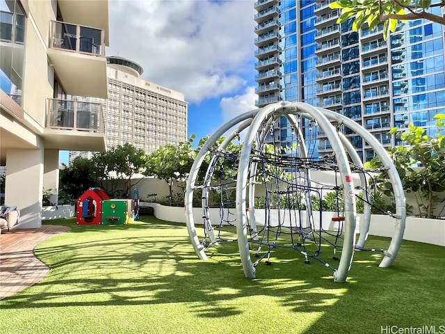 view of home's community with a lawn and a playground